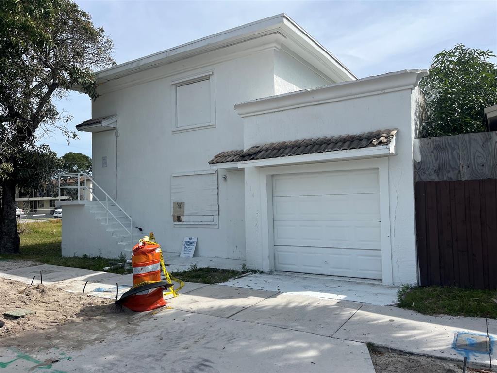 a view of a house with a garage and sitting area