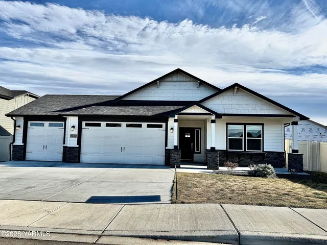 a room with a wooden floor and windows
