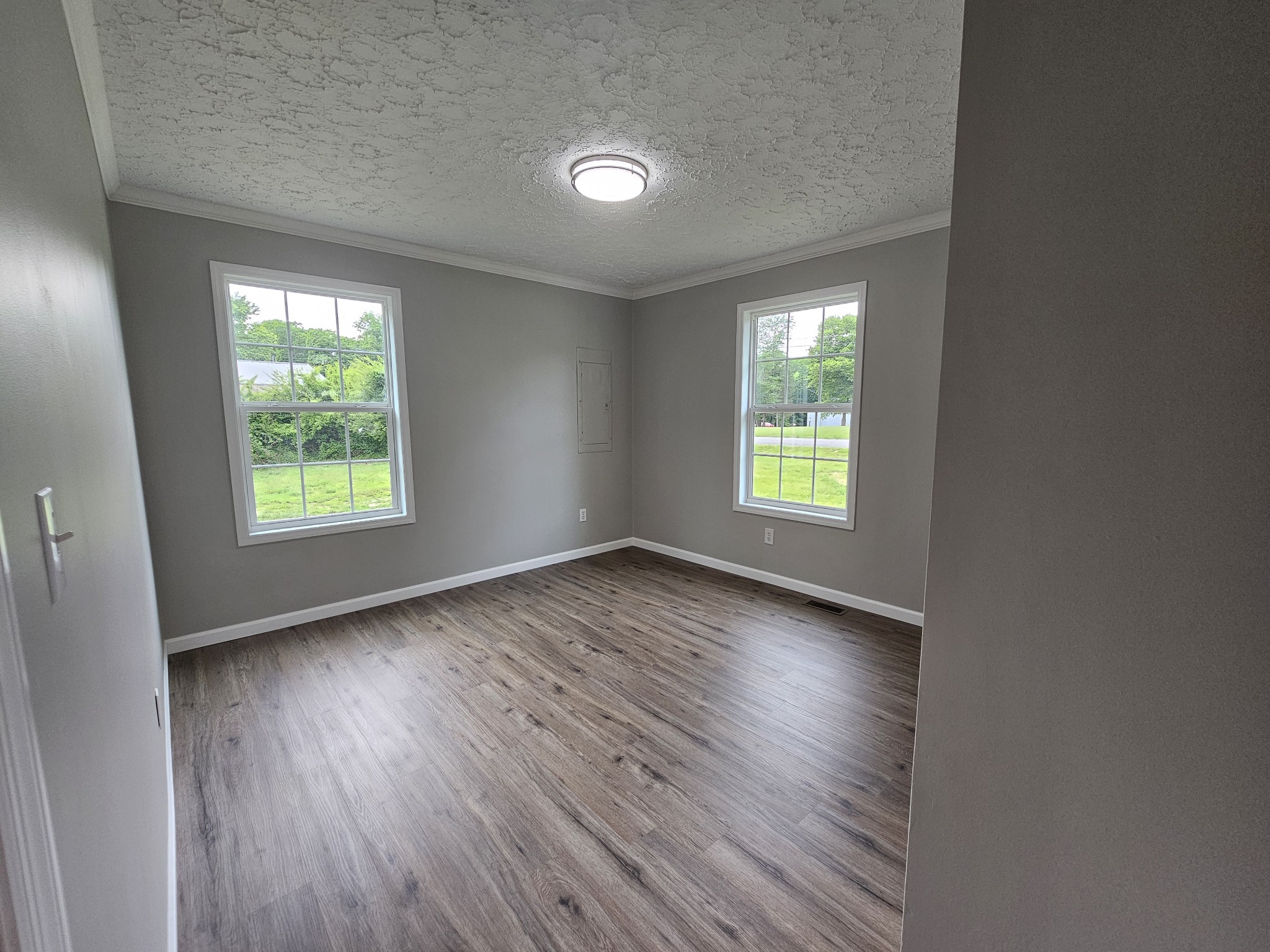 362 Forest Point Road Monteagle, TN 37356 - Photo 40 of 42 an empty room with wooden floor and windows