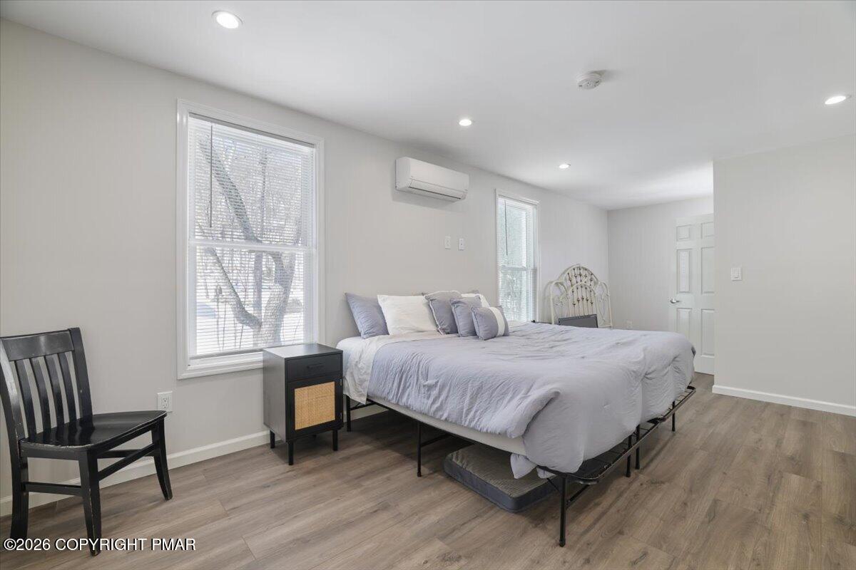 5873 Decker Road Bushkill, PA 18324 - Photo 5 of 57 a spacious bedroom with a bed and a window