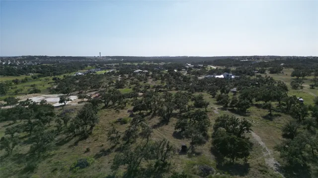 an aerial view of house with yard and mountain view in back