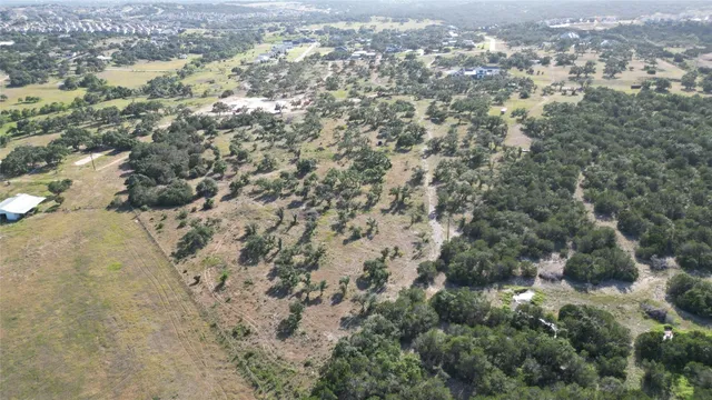 an aerial view of house with yard and mountain view in back