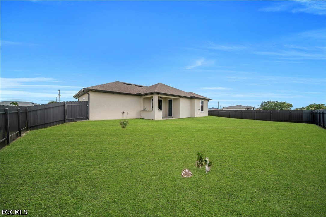 1128 Nelson Road North Cape Coral, FL 33993 - Photo 22 of 22 a view of an house with backyard and garden