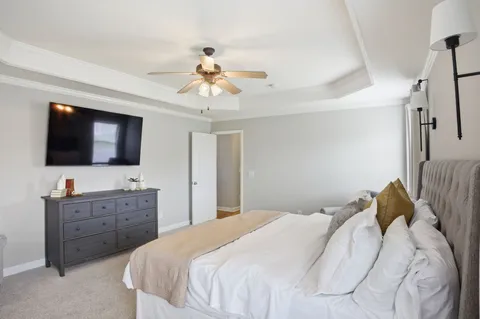 a bedroom with a bed and a flat screen tv