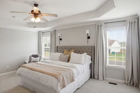 a bedroom with a bed and a chandelier