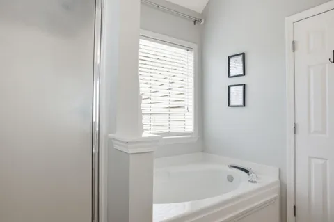 a white bath tub sitting next to a window