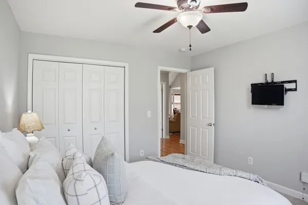 a bedroom with a bed and a chandelier