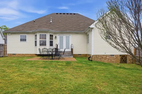 a view of a house with pool and chairs
