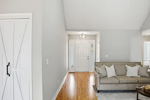 a living room with a couch and a wooden floor