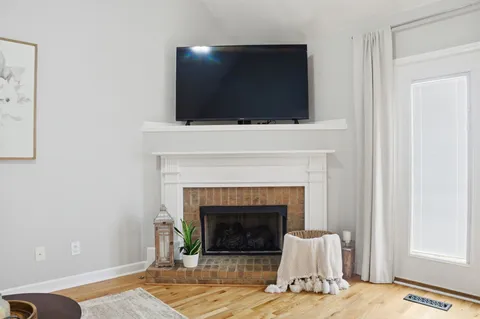 a living room with a fireplace and a flat screen tv