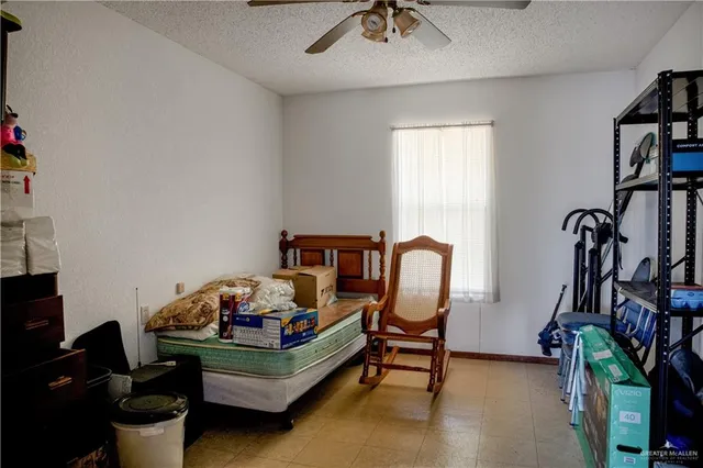 a bedroom with furniture and a book shelf