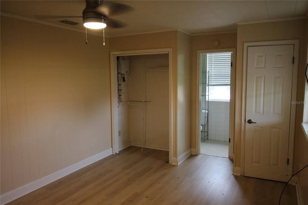 4820 Lake Gibson Park Road, Unit 3 Lakeland, FL 33809 - Photo 2 of 13 an empty room with wooden floor and windows