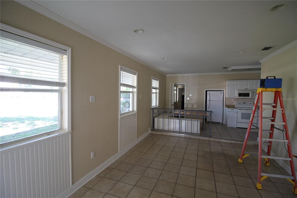 4820 Lake Gibson Park Road, Unit 3 Lakeland, FL 33809 - Photo 5 of 13 a room with lots of white furniture and a window