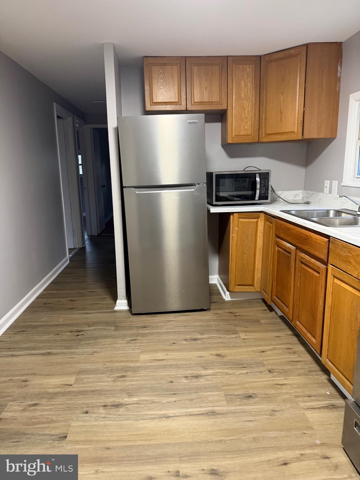 3018 Philadelphia Road Abingdon, MD 21009 - Photo 4 of 20 a kitchen with granite countertop a refrigerator a sink and white cabinets