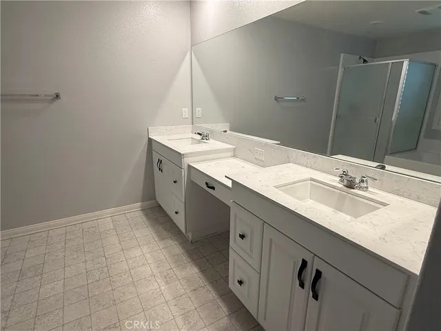a bathroom with a double vanity sink and mirror