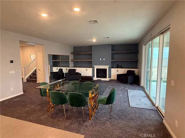 a living room with furniture a window and kitchen view