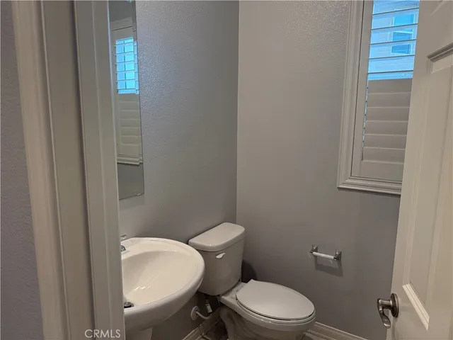 a white toilet sitting next to a bathroom sink