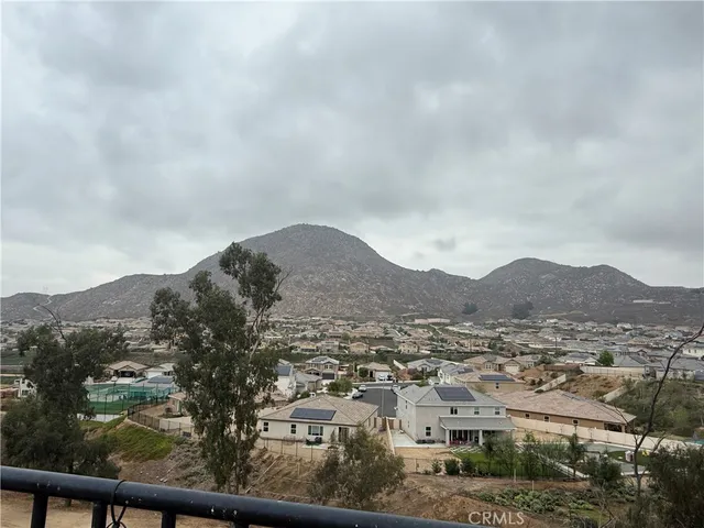an aerial view of residential houses with outdoor space and trees