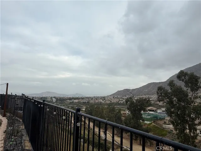 a view of city and mountain from a balcony