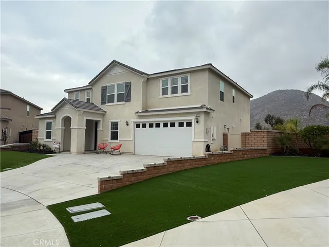 a view of a white house with a big yard and large trees