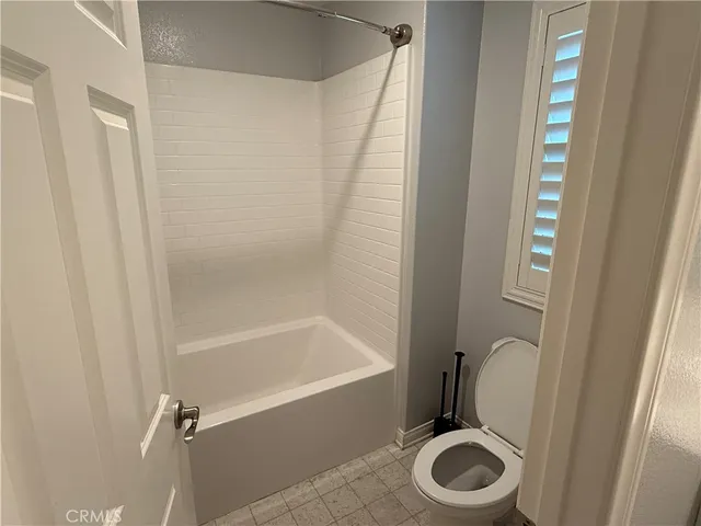 a bathroom with a toilet and a bathtub
