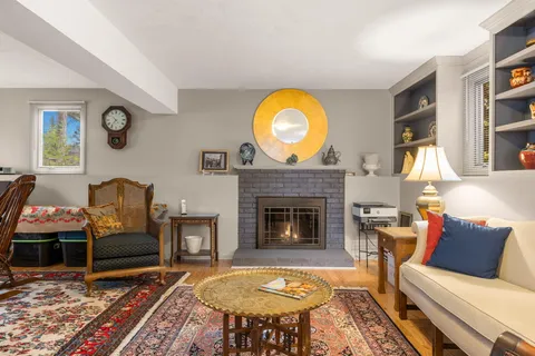 a living room with furniture a rug and a fireplace