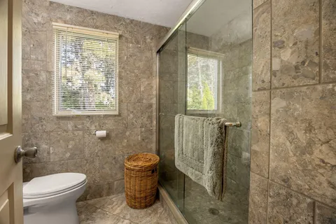 a bathroom with a toilet and a shower