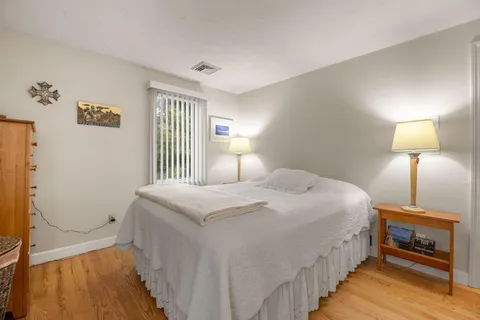 a bedroom with a bed and a lamp