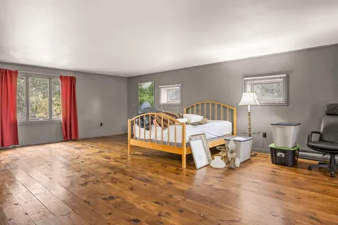 a bed room with a bed and a chair