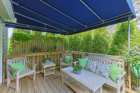 a view of a chairs and table in patio with a small yard