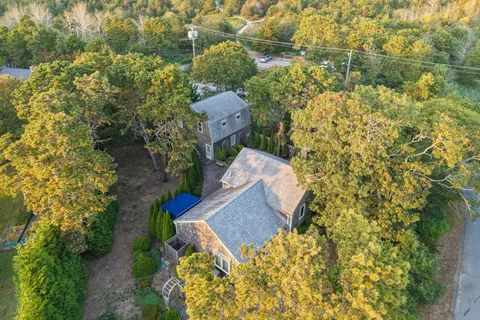 an aerial view of a house with a yard