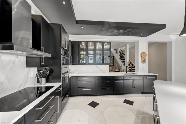 a kitchen with stainless steel appliances a sink and a stove