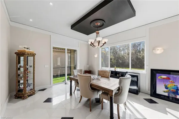 a living room with furniture a flat screen tv and a floor to ceiling window