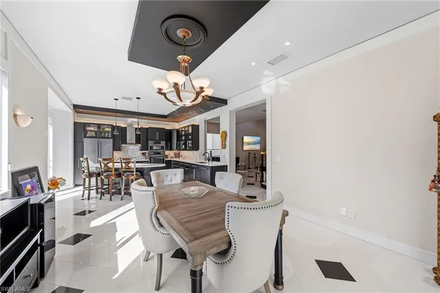 a view of a dining room and livingroom with furniture wooden floor and a clock