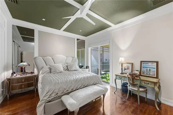 a bedroom with furniture and a wooden floor