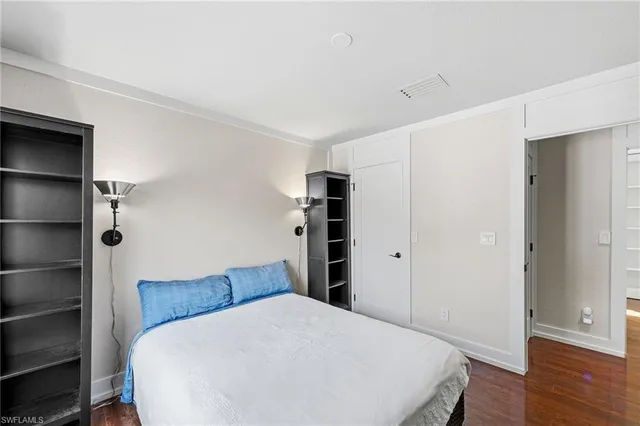 a bed room with a bed and wooden floor