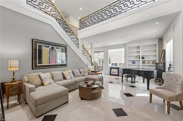 a living room with lots of furniture and white walls