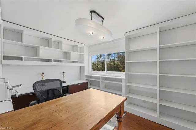 a room with furniture a rug and white walls
