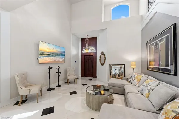 a living room with furniture and a mirror