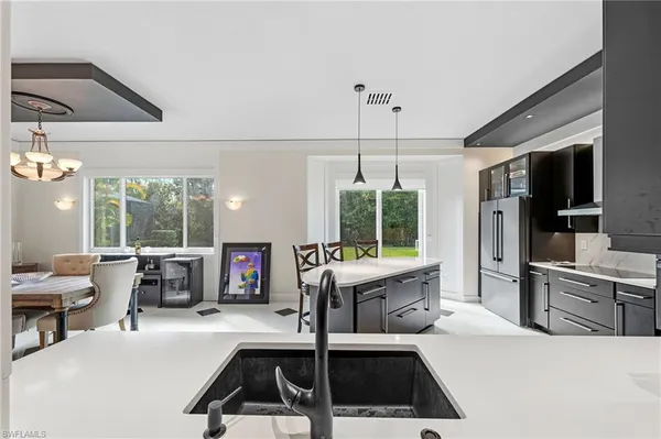 a kitchen that has a lot of cabinets refrigerator oven and a sink