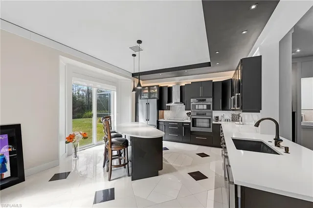 a kitchen with a sink appliances and cabinets