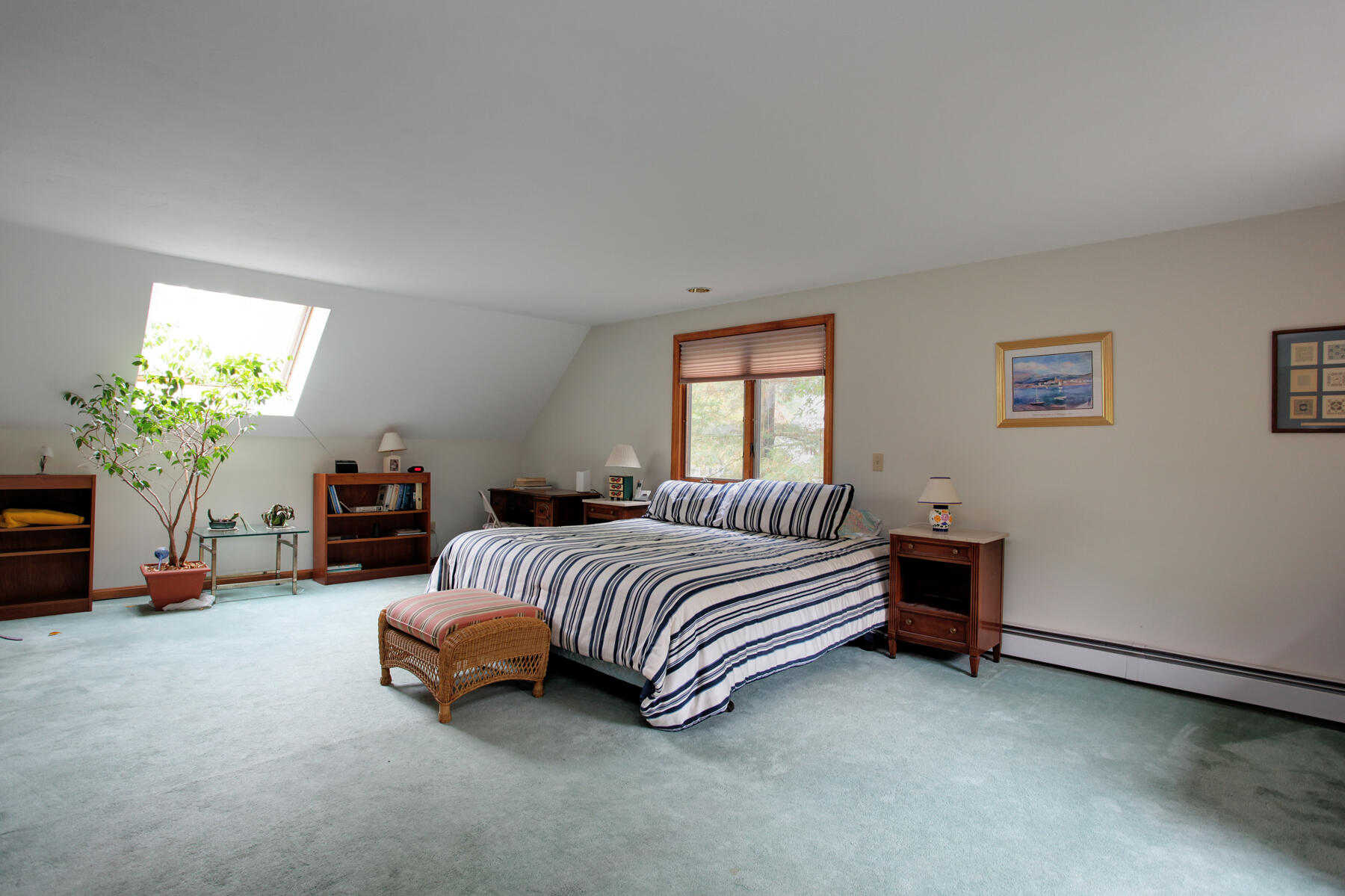 62 Pine Ridge Road Cotuit, MA 02635 - Photo 17 of 31 a spacious bedroom with a bed and a chandelier