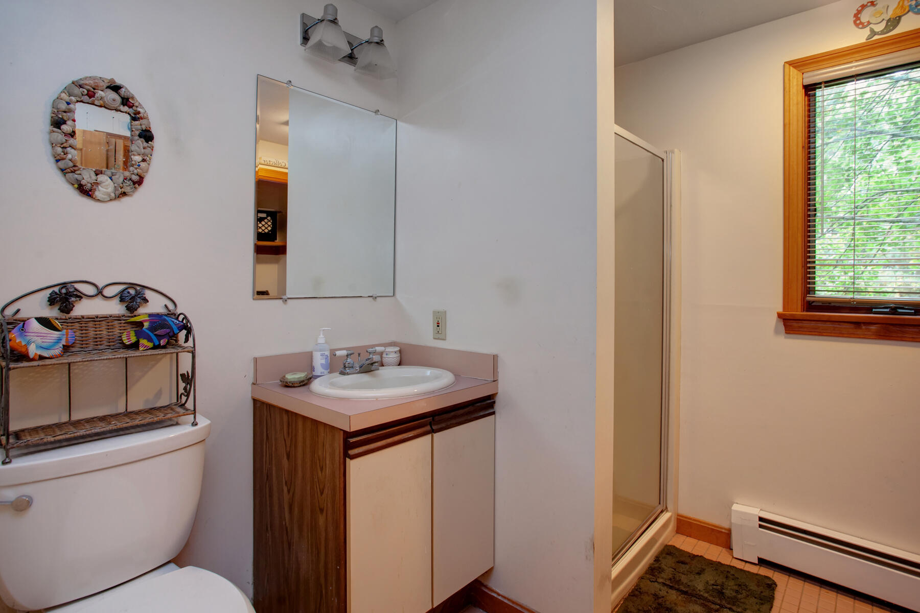 62 Pine Ridge Road Cotuit, MA 02635 - Photo 20 of 31 a bathroom with a toilet sink and mirror