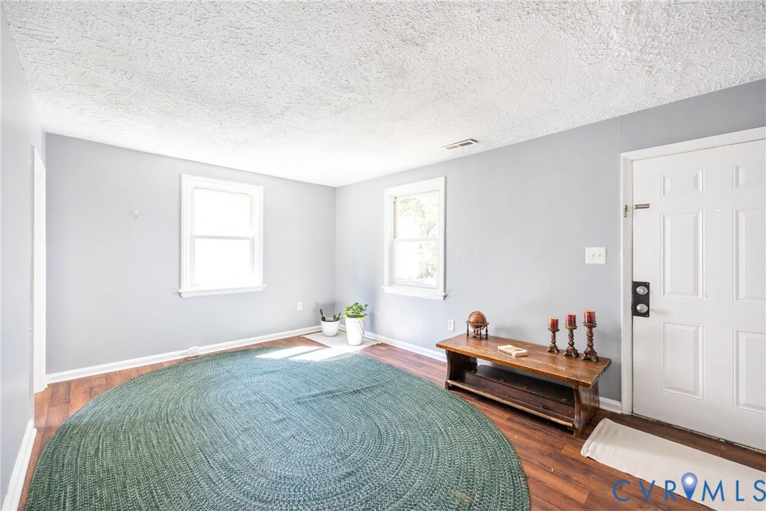 3505 Meadowbridge Road Richmond, VA 23222 - Photo 5 of 20 Spacious room with hardwood flooring, soft gray wa