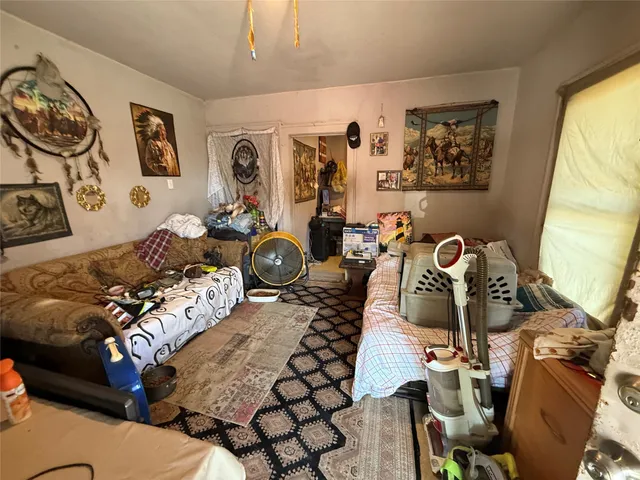 a bedroom with furniture and wooden floor