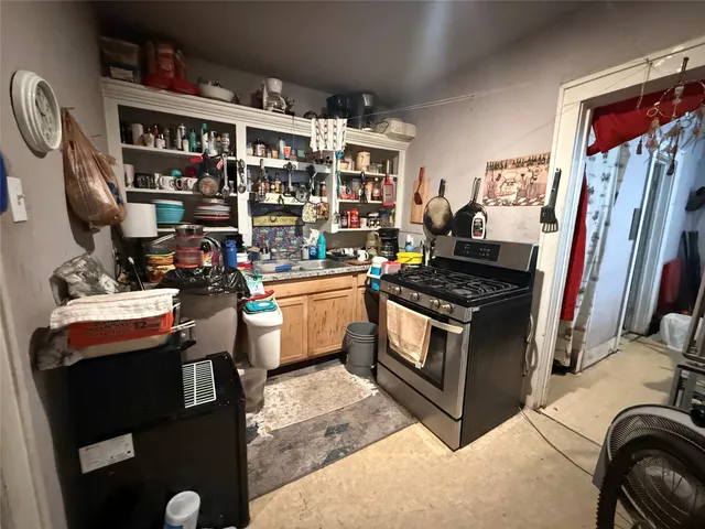 a kitchen with stainless steel appliances granite countertop a stove and a sink