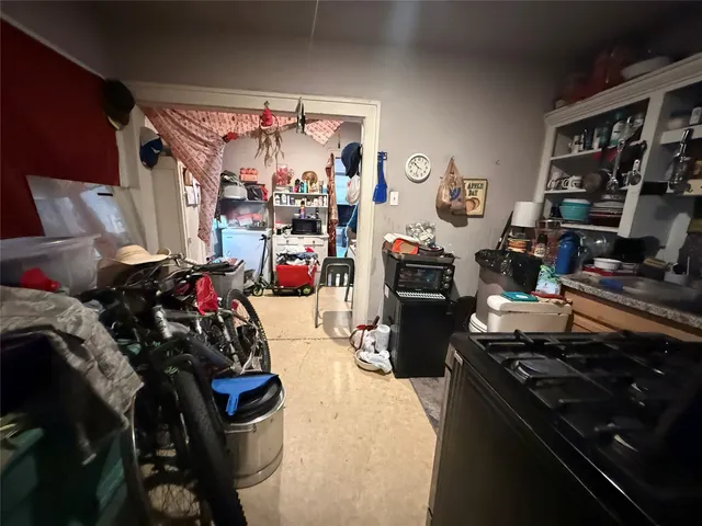 a kitchen with a refrigerator and a stove top oven