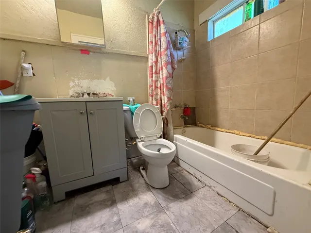 a bathroom with a toilet a sink and bathtub