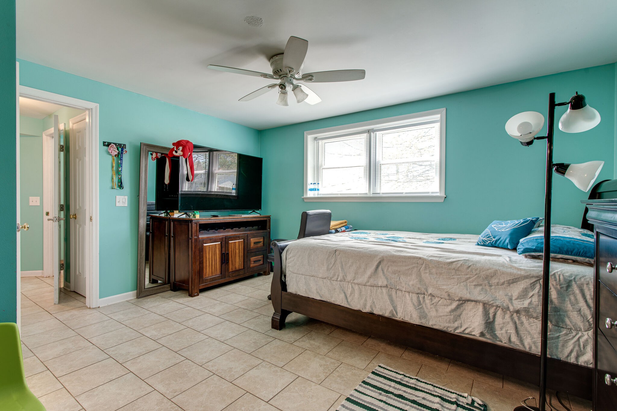 116 Tusculum Road Antioch, TN 37013 - Photo 19 of 27 a bedroom with a bed and a flat screen tv