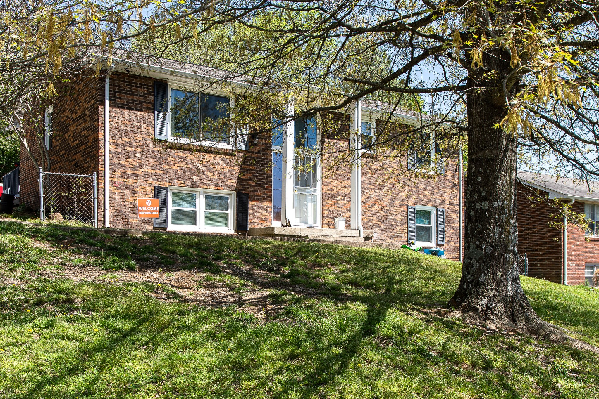 116 Tusculum Road Antioch, TN 37013 - Photo 3 of 27 a view of a brick house with a large windows and large tree